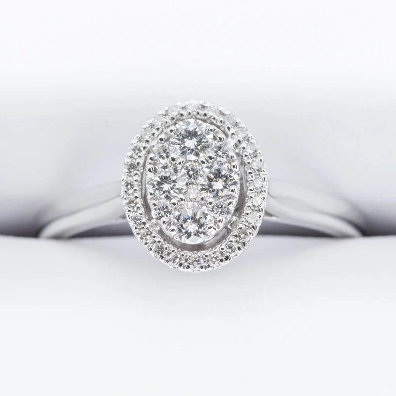 modern engagement rings-18ct White Gold Oval Diamond Halo Cluster Ring